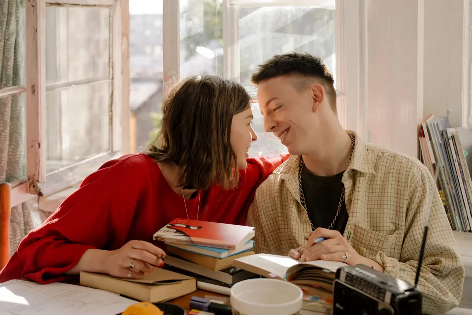A loving couple enjoying study time together in a cozy, well-lit room.