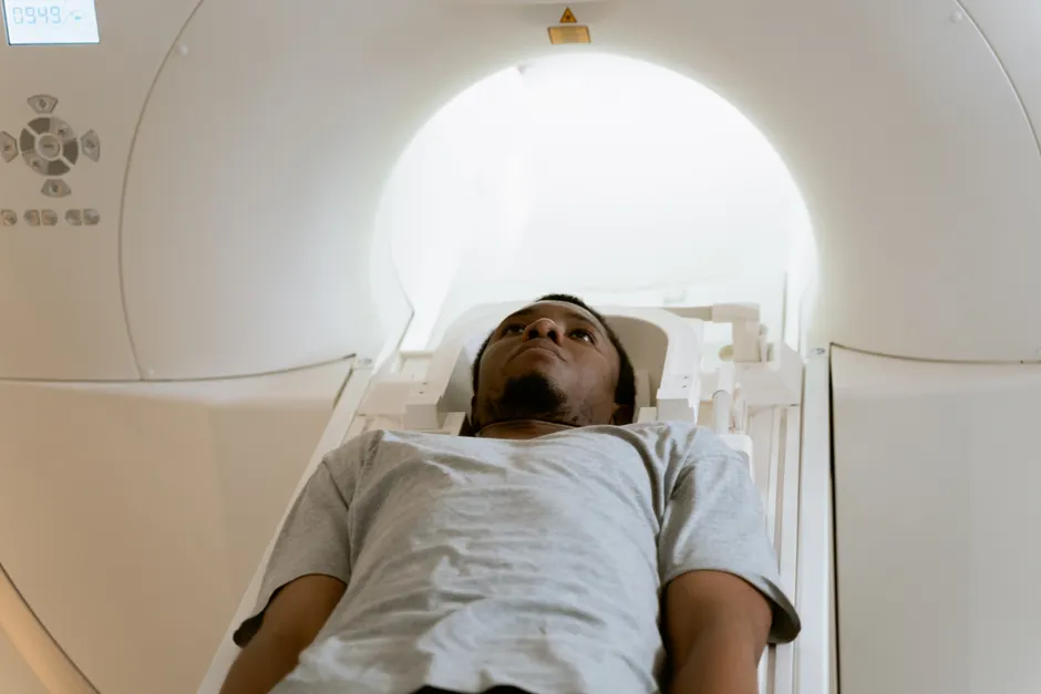 A patient laying inside an MRI machine during a medical scan at a healthcare facility.
