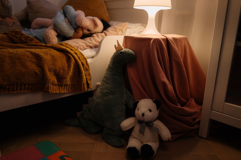 A warm and cozy child's bedroom setting with plush toys and soft lighting creating a peaceful ambiance.