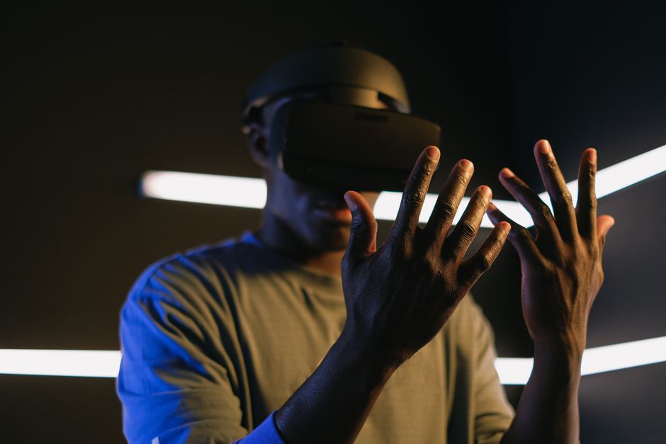 Focused view of a person using VR goggles and exploring virtual reality. Captures modern technology theme.