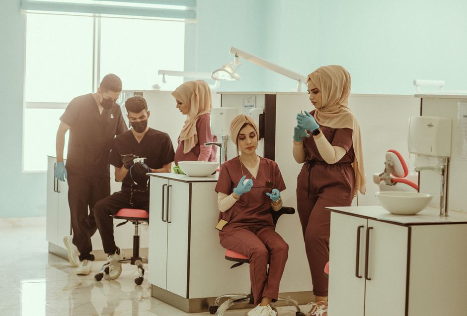 Group of diverse medical professionals in a clinic, focused on healthcare tasks.