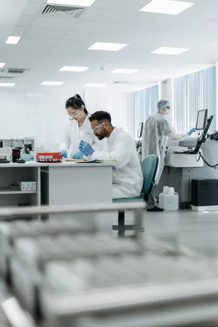 Scientists in a high-tech lab conducting research, analyzing data with advanced equipment.