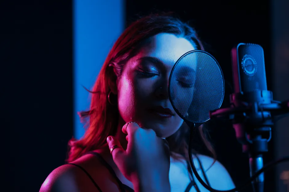 Schizophrénie en 2026 : quatre résultats à interpréter sans raccourci A captivating portrait of a female singer with closed eyes performing in a dimly lit recording studio.