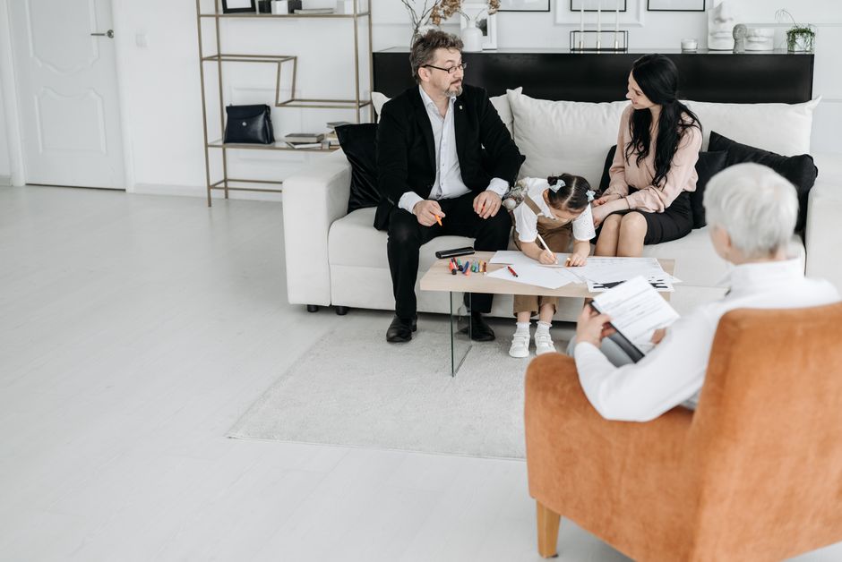A family discussing adoption plans with a social worker in a cozy office environment.