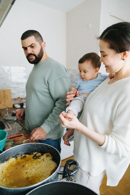 A family preparing a meal together in their kitchen, showcasing togetherness and home-cooking.