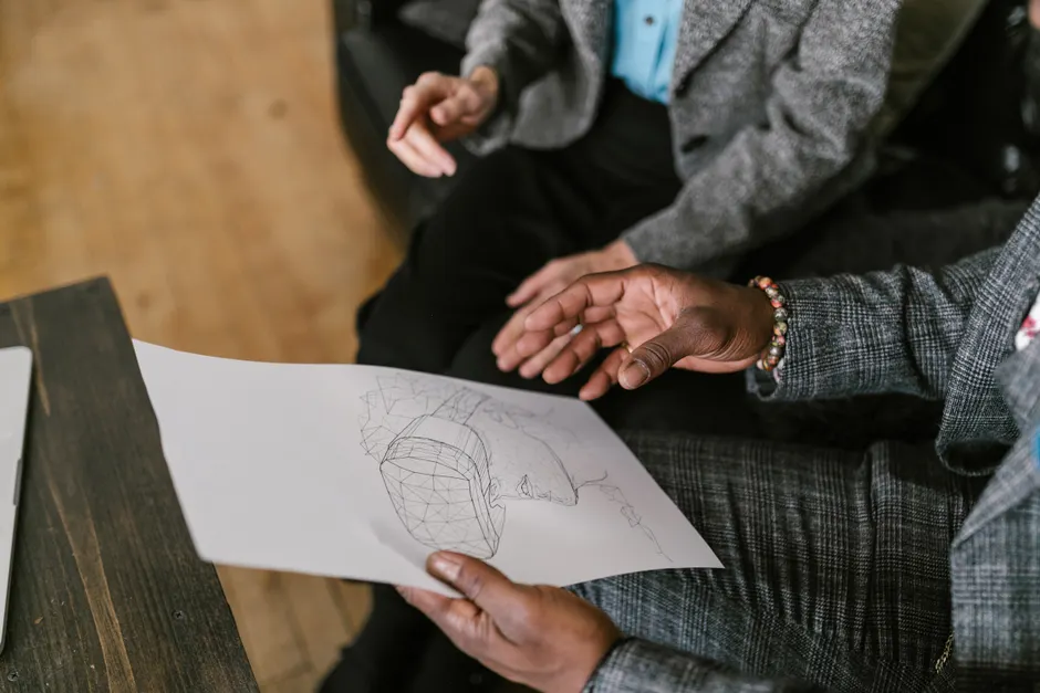 Business professionals discussing virtual reality design ideas during a meeting.