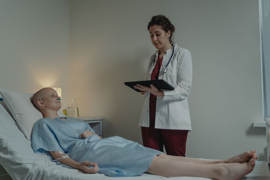 Doctor discusses treatment with patient in hospital, illustrating compassionate healthcare.