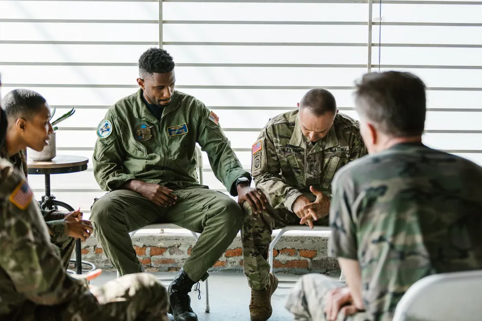 Soldiers in a supportive group therapy session focusing on mental health and recovery.