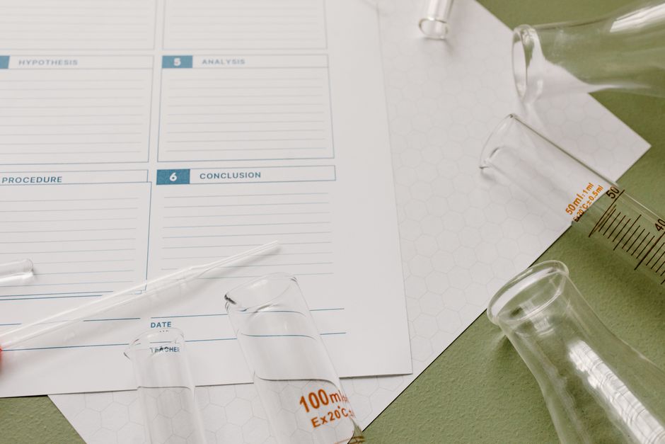 Top view of laboratory glassware and a scientific form for research documentation.