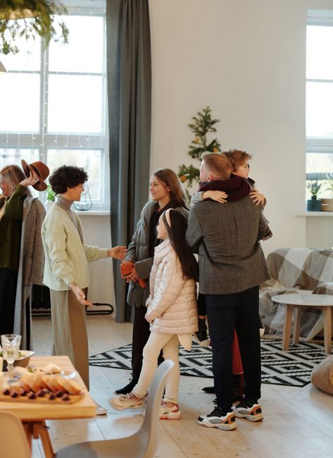 Warm family reunion with cozy holiday decorations indoors during Christmas season.