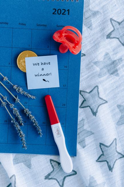 A pregnancy test with a positive result on a 2021 calendar, symbolizing new beginnings.