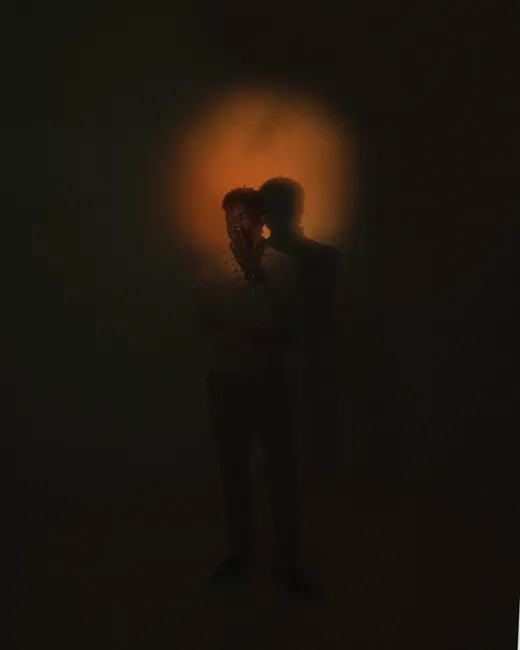 A silhouette of a person with a glowing aura, creating a mysterious and artistic effect.