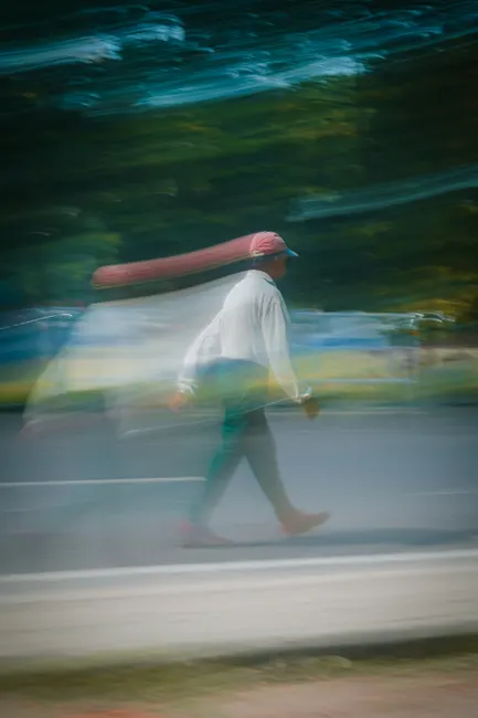 Artistic motion blur capturing a person walking on a city street in India, conveying a sense of movement and dynamism.