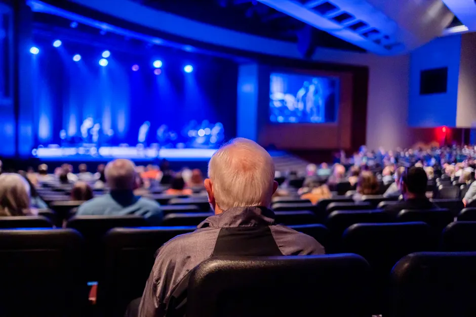 Audience seated in a theater watching a captivating live performance on stage.