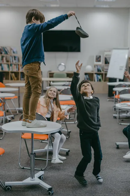 Children playing in a modern classroom, showcasing active learning.