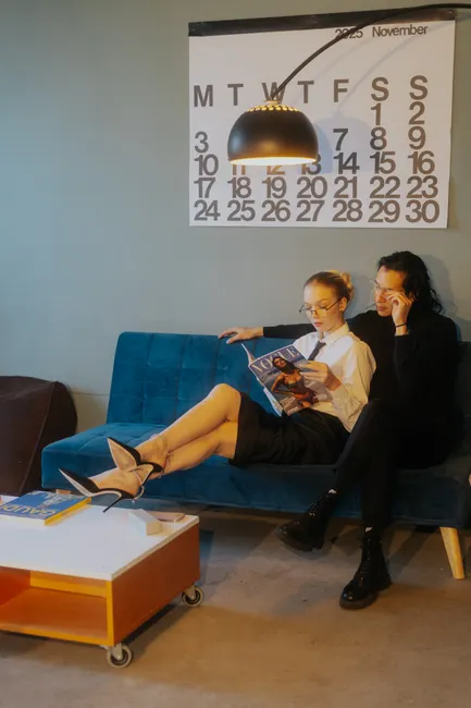 Couple enjoying a cozy evening in a stylish Berlin apartment with a November calendar backdrop.