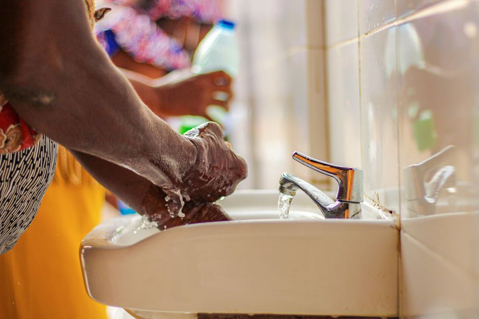 Germaphobie : quand la peur des microbes rétrécit la vie Side view of crop unrecognizable ethnic person in colorful apparel washing hands with soap in sink